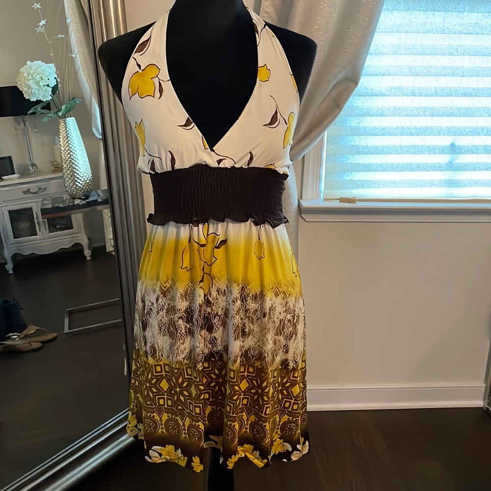 Stretchy yellow/brown dress that ties at neck. Dress falls just above knees.